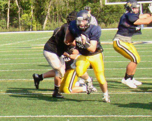 SENIOR QUARTERBACK Jake McHugh heads for the end zone on a 16–yard touchdown run in the preseason scrimmage against Northeast Metro Tech. He earned the position after an impressive preseason performance in three scrimmages. (Tom Condardo Photo)