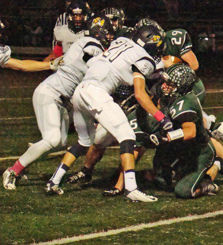 CAPTAIN CJ Finn (11) and Evan Battaglia (21) team up to stop Hornet running back Chris Carr (29) in Friday's 32-0 shut out. (Tom Condardo Photo)