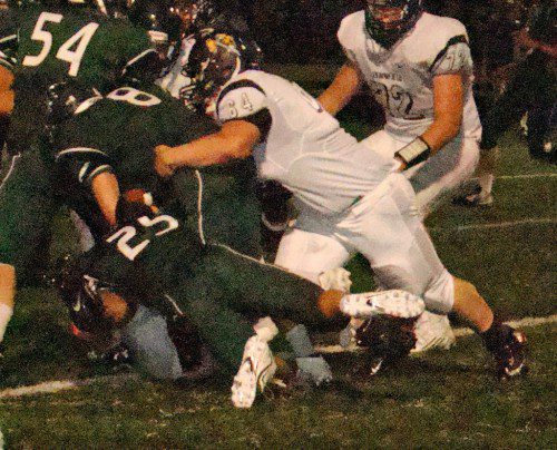 PIONEER Matt Giannasca (64) wraps up Hornet Robbie Sarmanian (8) for a loss in Friday night’s victory. (Tom Condardo Photo)