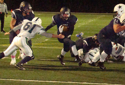 FIRST TIMER. Sophomore Cameron Lilley (32) rumbles through a hole opened by his teammates, including, Zack Huynh (left), for his first varsity TD. The score came in the fourth quarter vs. H-W. (Tom Condardo Photo)
