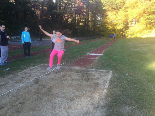 "I'M FLYING." Kaleigh Weeks flies through the air in the long jump during the middle school track and field meet. (Courtesy Photo)
