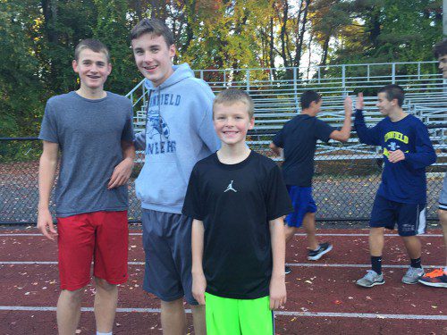 FAMILY LEGACY. The Shone brothers, from left: Zac, a sophomore; Harry, a senior; and Andrew, a sixth-grader, had fun together at the middle school track meet during which LHS athletes mentored future Pioneers. (Courtesy Photo)