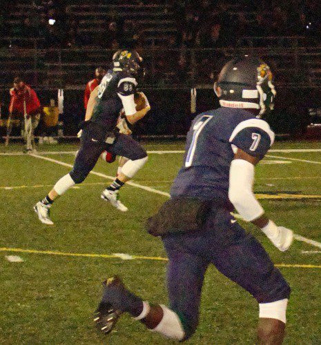 LOUIS ELLIS (85) is off on an 85-yard touchdown reception in first quarter action as senior Easie Philantrope (7) heads out to block the Raiders. (Tom Condardo Photo)