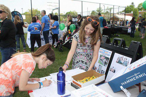 STAYING in the lines. Elizabeth Calnan (left) and Emilie Bell, both 10, had fun entering the Villager’s coloring contest at Townscape’s Kids Day Saturday. There is still time for kids up to age 12 to win a $50 gift certificate to Meletharb’s Ice Cream and a gift subscription to the newspaper. Simply pick up entries at our office, 26 Albion St., Wakefield, and submit them by Wednesday, June 1. (Maureen Doherty Photo) 