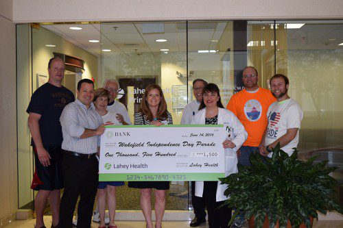 LAHEY HEALTH IS A SPONSOR of this year's Fourth of July Parade. From the left are Wakefield Independence Day Committee volunteer Greg Powers; Dr. Douglas Fritz; WIDC volunteer Lois Benjamin; WIDC volunteer Dan Benjamin; Christine Healey; WIDC volunteer Jack Billiel; Dr. Lisa Connolly; WIDC volunteer Brian Fox and WIDC Chairman Patrick Sullivan. (Amy Braid Photo)