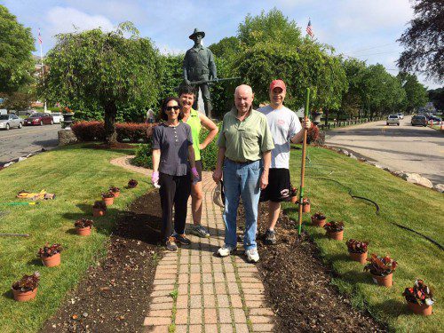 LAST SATURDAY members of the Wakefield Center Neighborhood Association planted 60  begonias on the Rockery. They replaced the hundreds of tulips that had been planted last fall (and bloomed this spring). This is an annual tradition by the WCNA to keep the Rockery beautiful. Capone Landscaping generously donated the flowers. From the left are Fran Harrington, Beth Hendriks, Rich Stevens and Joe Harrington. (Harold Regan Photo)
