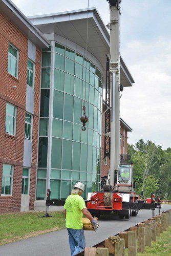 A CRANE was brought in last week to replace two damaged air handling units (for heating and cooling) on the high school roof prior to the first day of school. (Bob Turosz Photo)